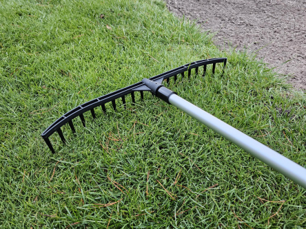 golf course bunker rake with built in stand